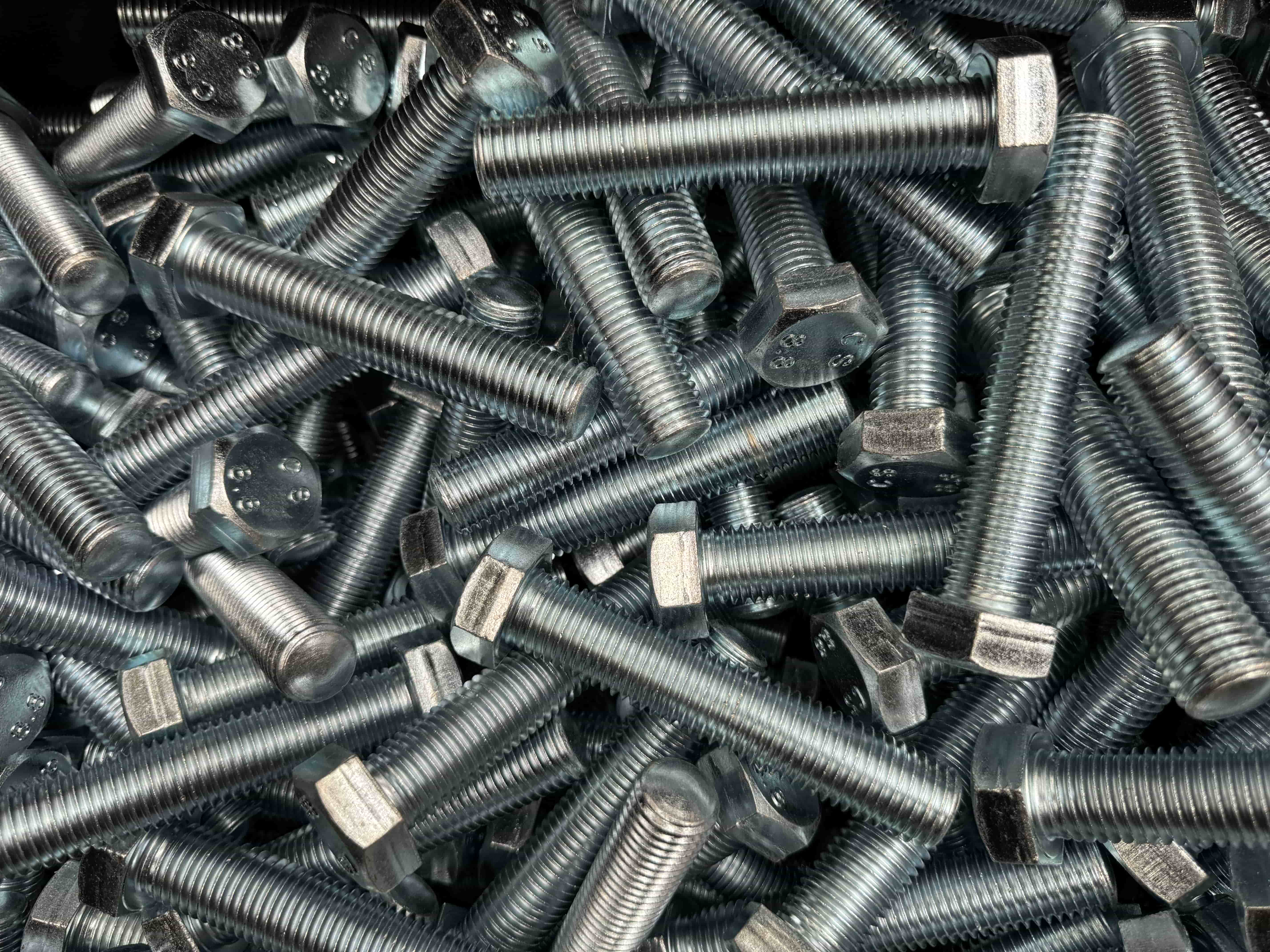 Assorted metal hex-head bolts with threaded shanks.