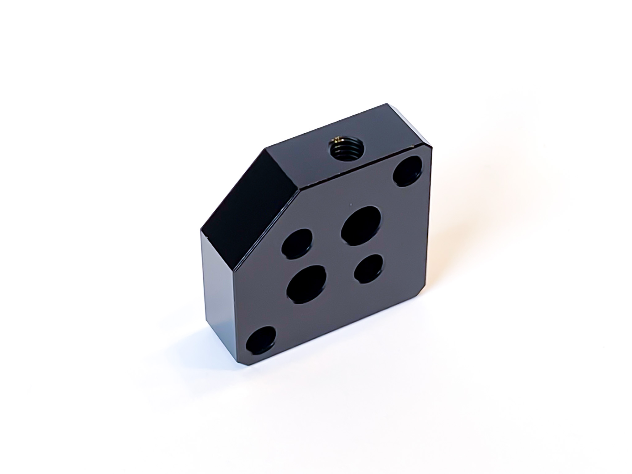 Black anodized machined aluminum block